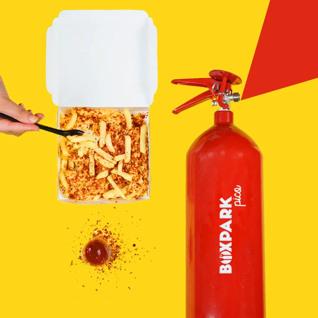 Hot fries poured beside a BoxPark-branded fire extinguisher
