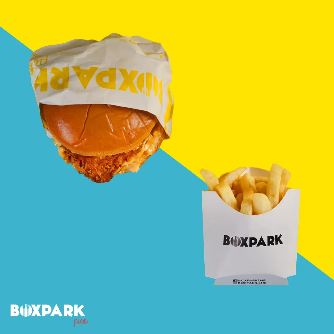 A chicken burger and fries on yellow and cyan