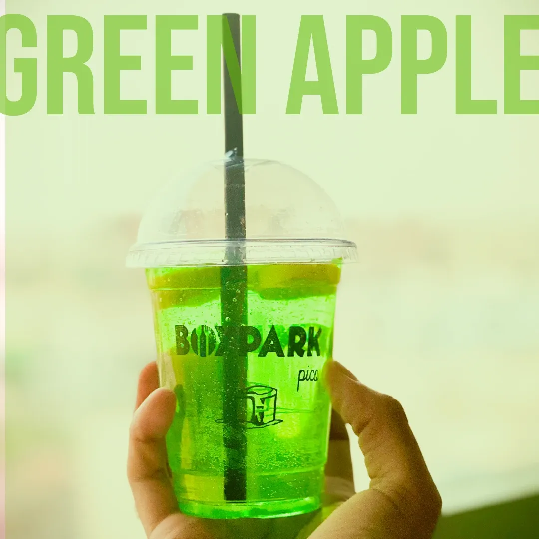 Green Apple Mind Crusher held up against daylight