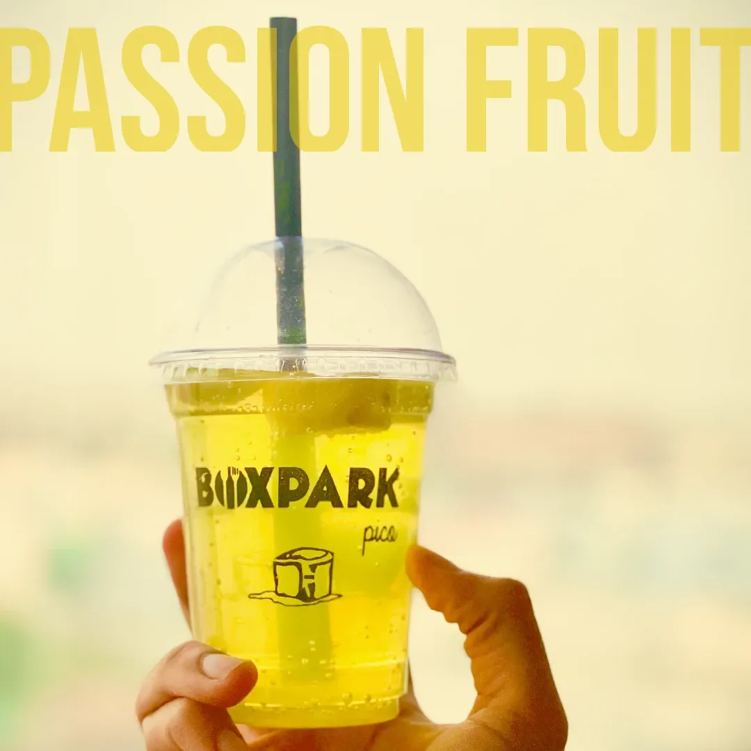 Passion Fruit Mind Crusher held up against daylight