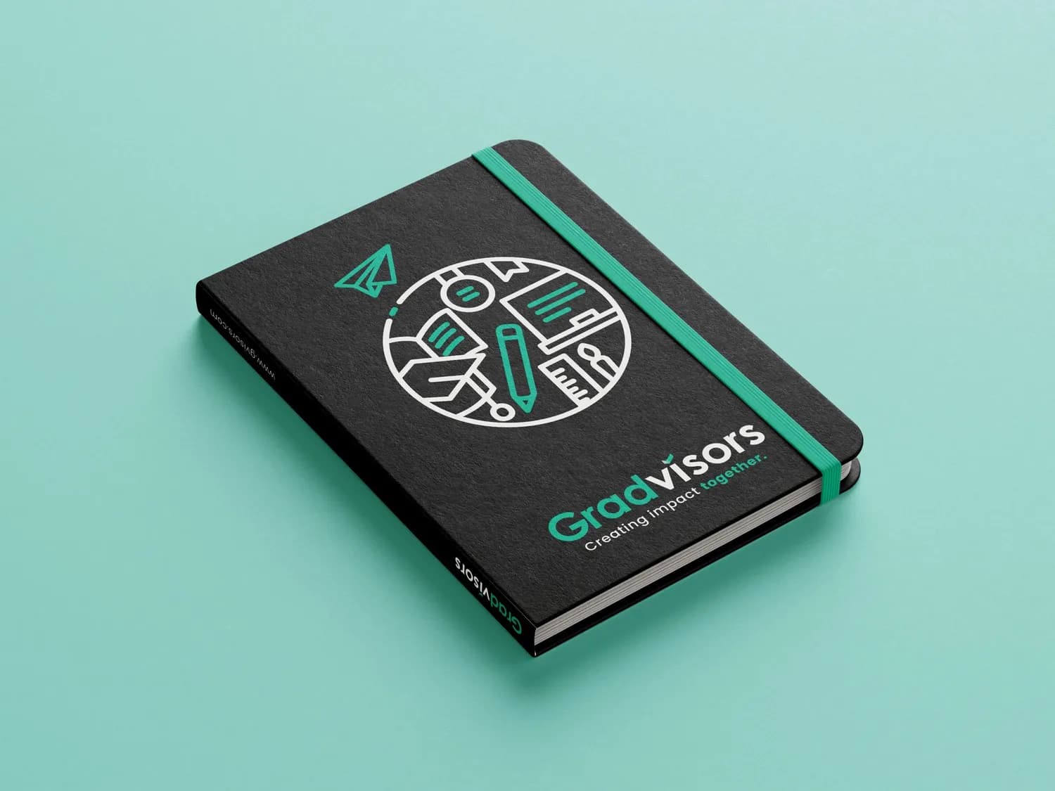 Charcoal notebook with a mint elastic band, printed with the Gradvisors badge and the line Creating impact together