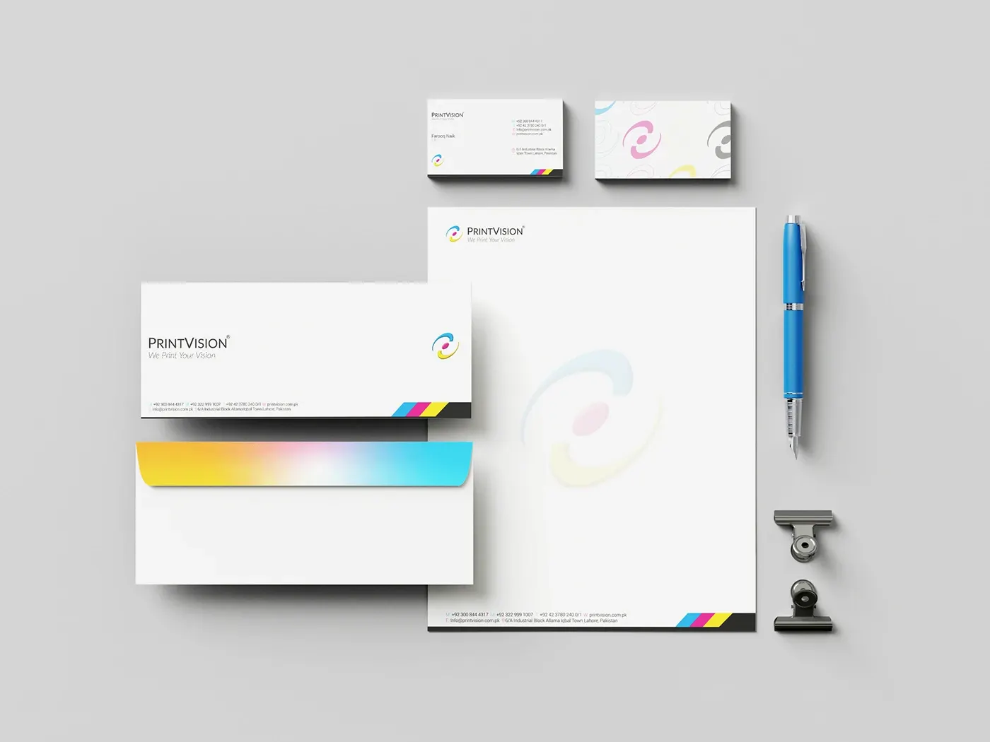 Letterhead, business cards, envelope and pen on a light surface