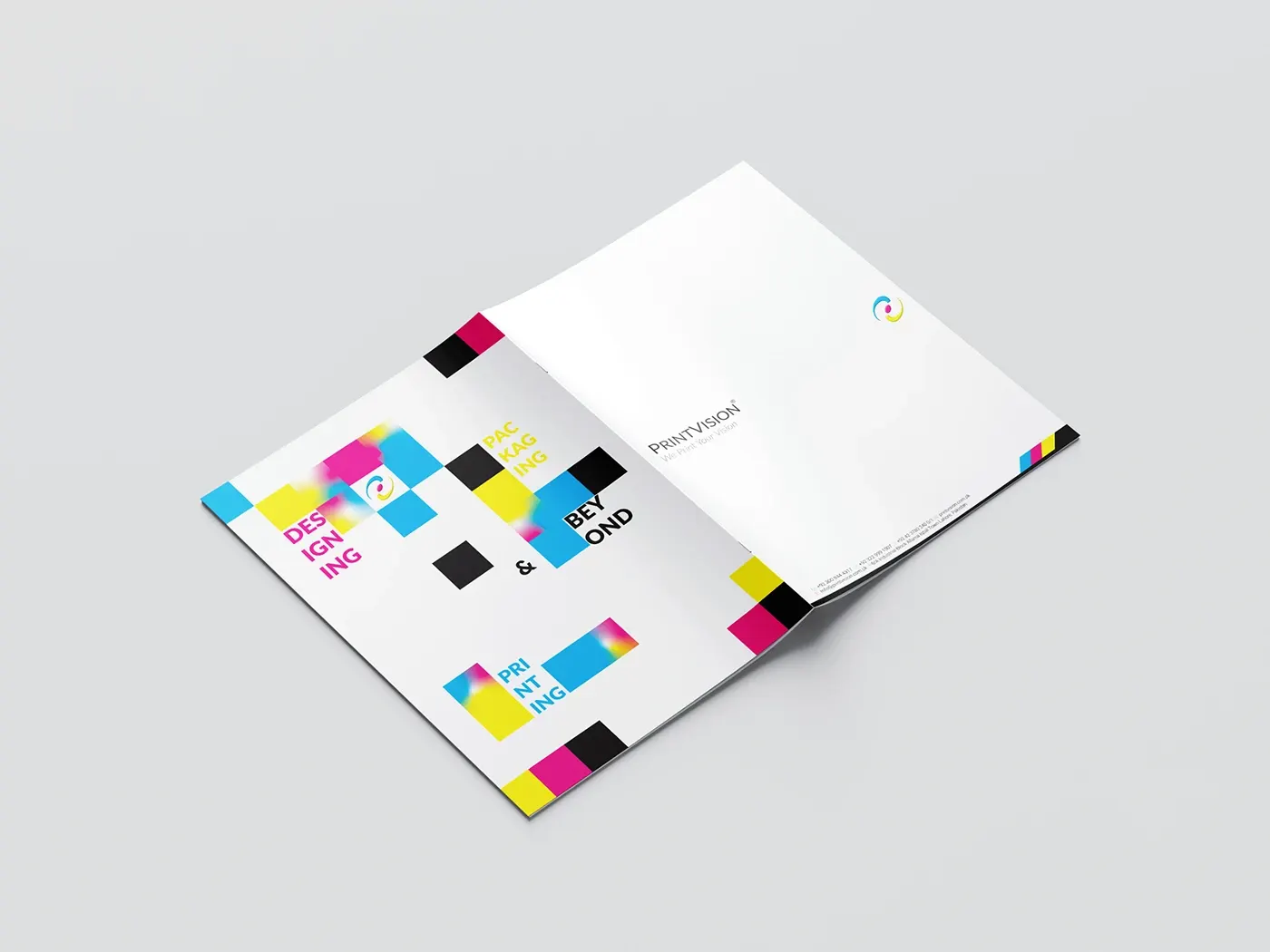 Open brochure spread with CMYK colour blocks