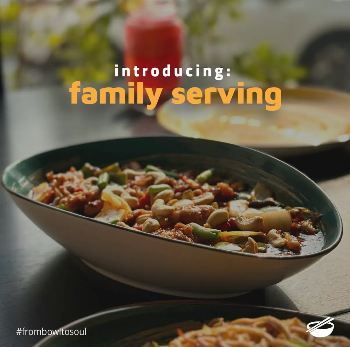 Post reading introducing family serving over a large bowl of noodles
