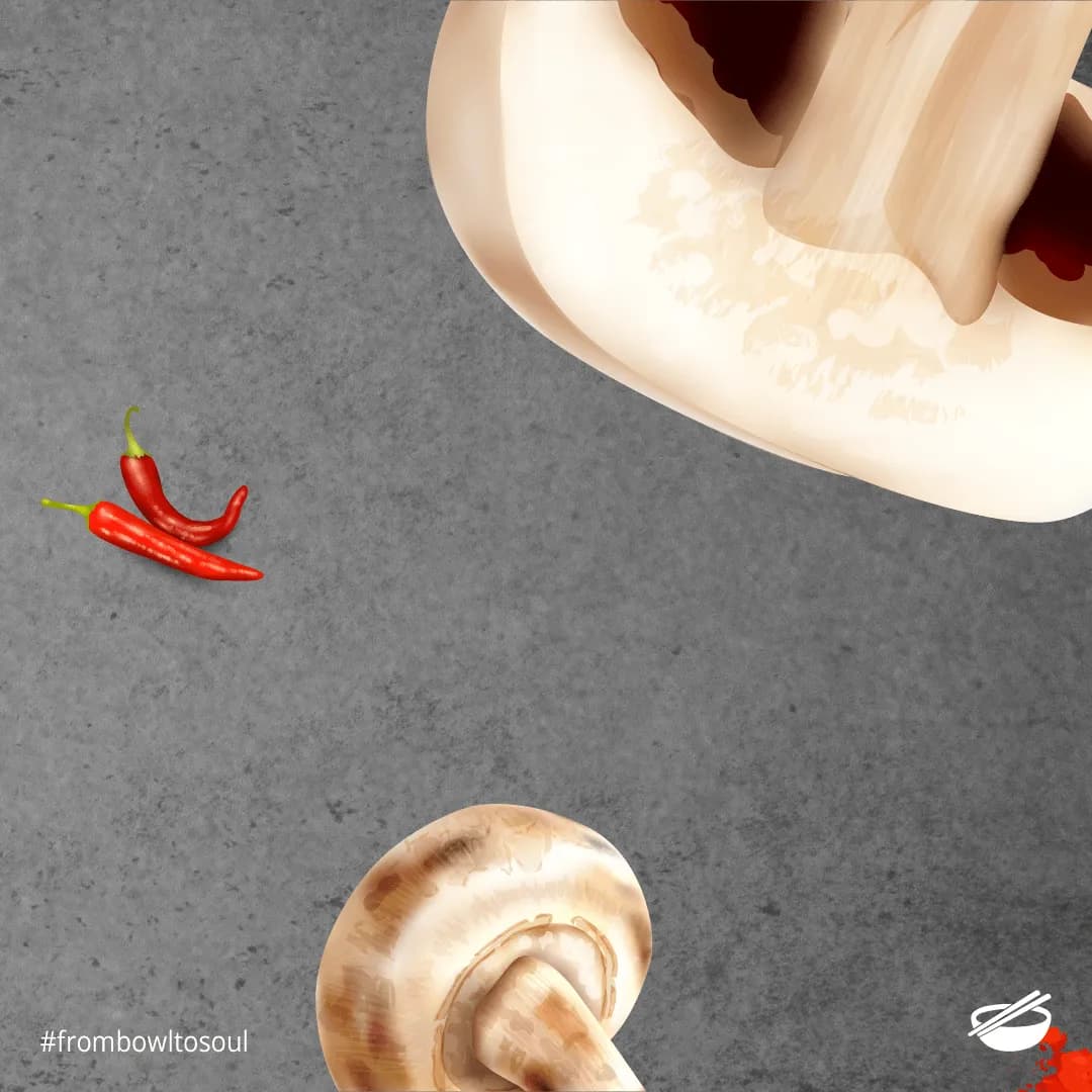 Red chillies and garlic falling against a grey concrete backdrop