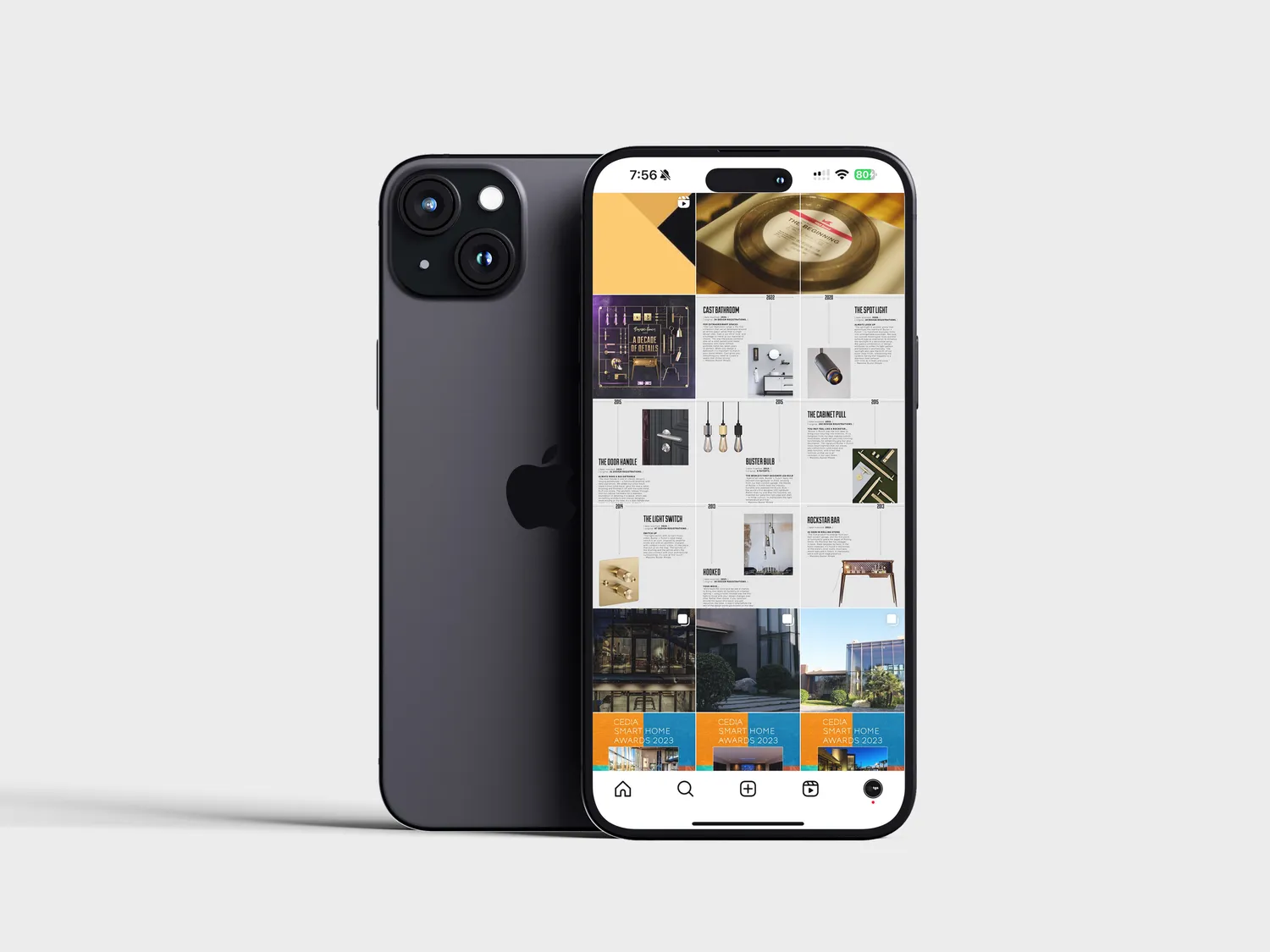 Phone showing a colourful Instagram grid of interiors and products, with the phone's back visible